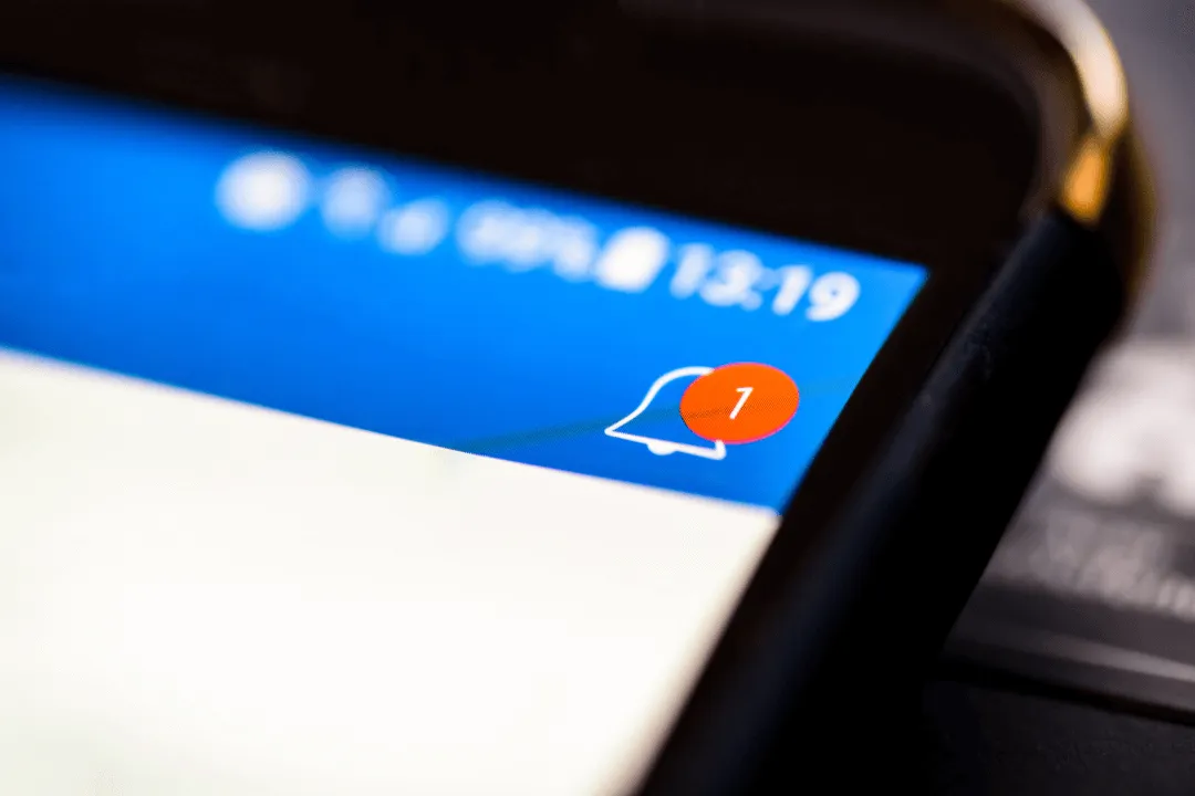 A close-up of a phone notification bell showing one unread alert